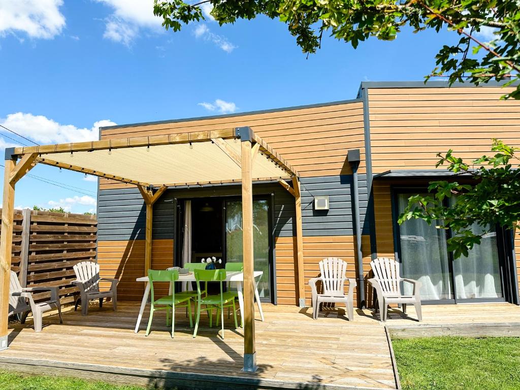a patio with a table and chairs on a deck at Gites-domainedupin, cottage "Mosnes à Lisa" in Mosnes