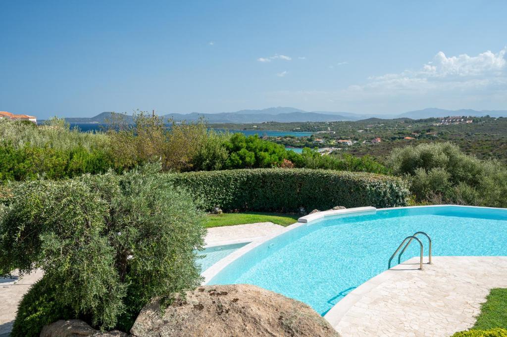 een zwembad in een tuin met uitzicht bij Sherden suites - Your House in Sardinia in Golfo Aranci