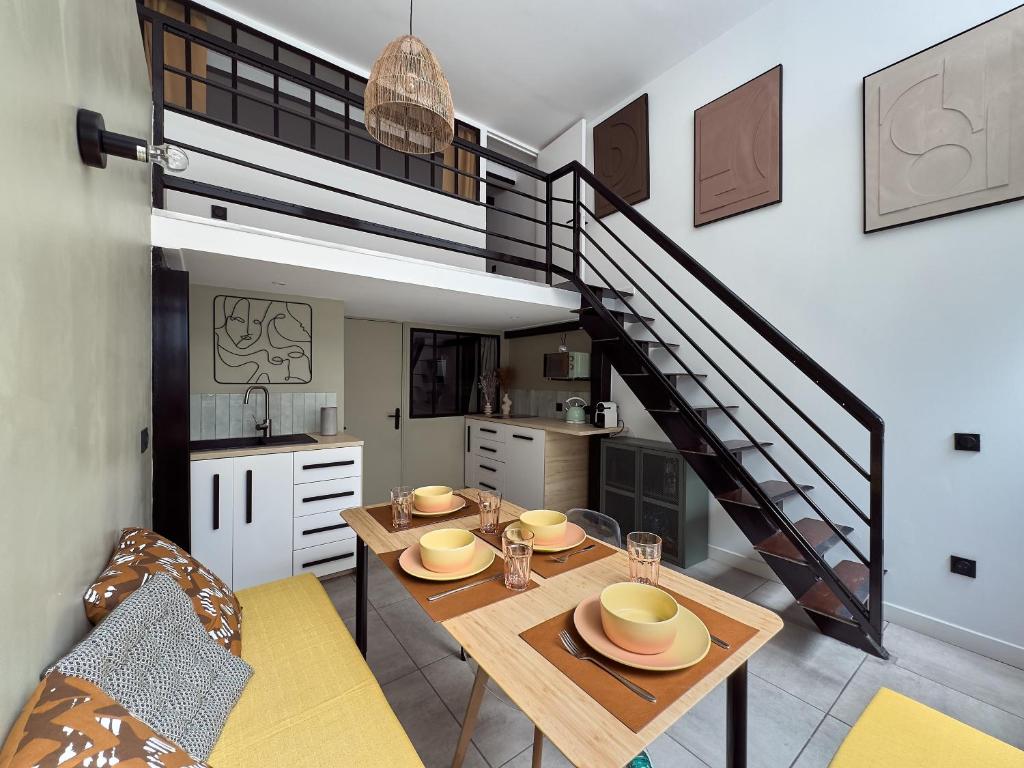 une salle à manger avec une table et un escalier dans l'établissement Pépite entre Le Panier et le Vieux-port, à Marseille