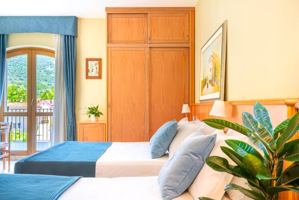 Postel nebo postele na pokoji v ubytování Albergo Il Giardino del Rio