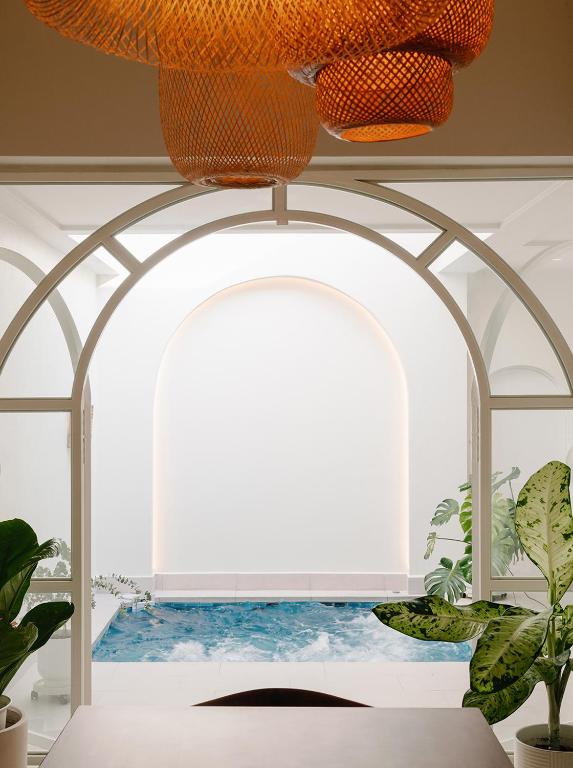 an archway in a room with a pool of water at Mint Villa with Jacuzzi Pool in George Town