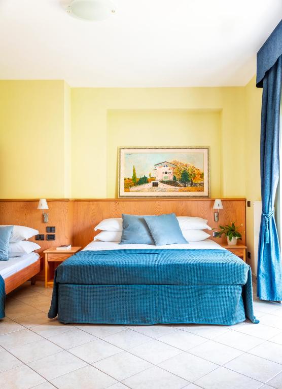 Postel nebo postele na pokoji v ubytování Albergo Il Giardino del Rio