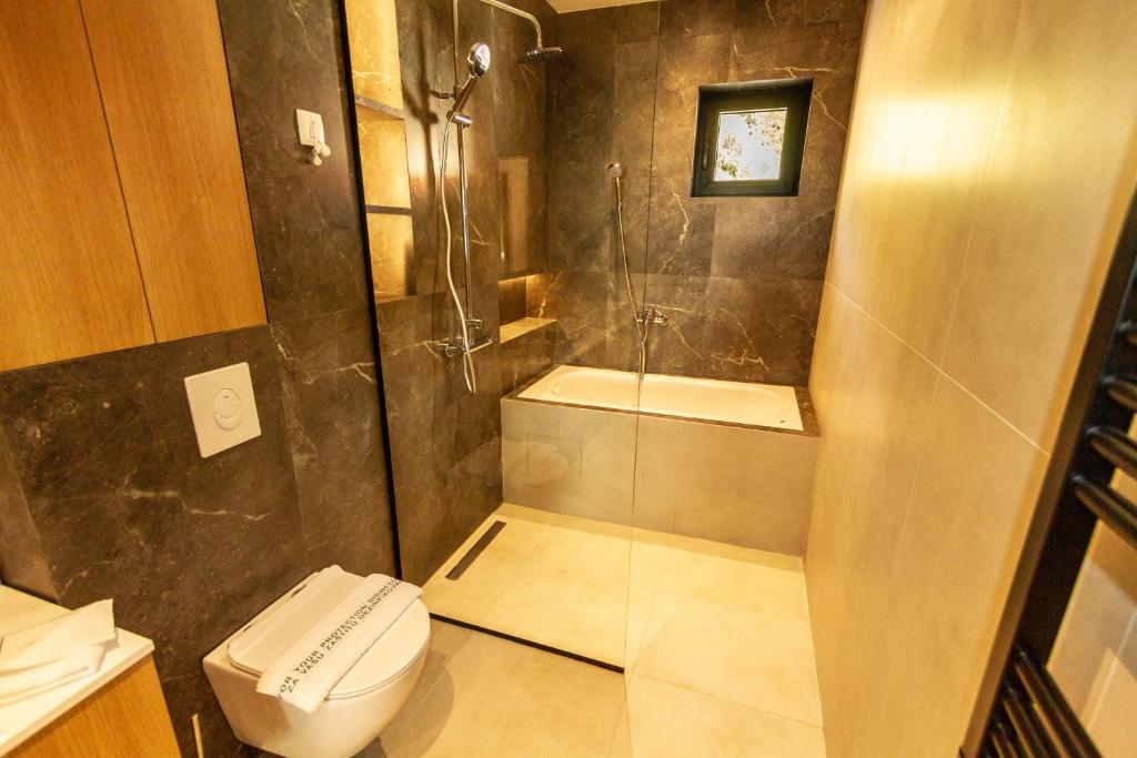 a bathroom with a shower and a toilet at Regent Resort Budva in Budva