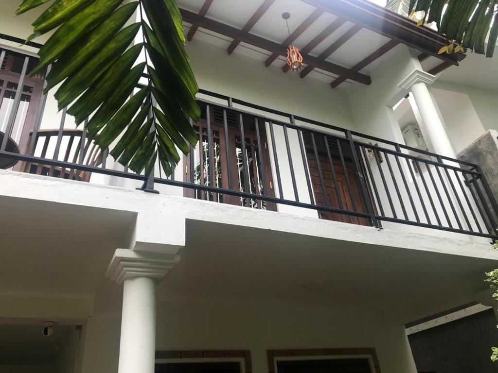 a balcony of a house with a railing at Flip Flop Inn Mirissa in Mirissa