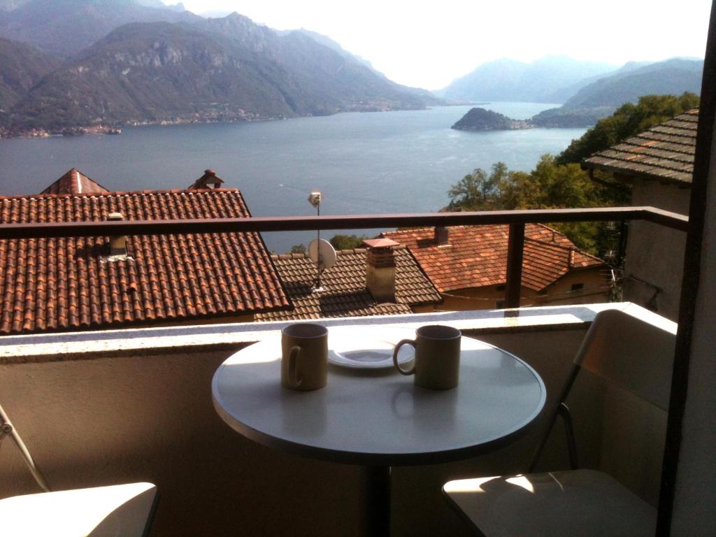 a table on a balcony with a view of a lake at Casa Logo in Plesio