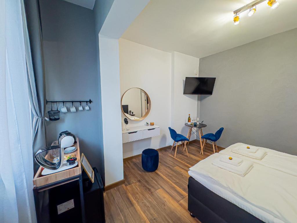 a hotel room with a bed and a mirror at Central Apartments in Veliko Tŭrnovo