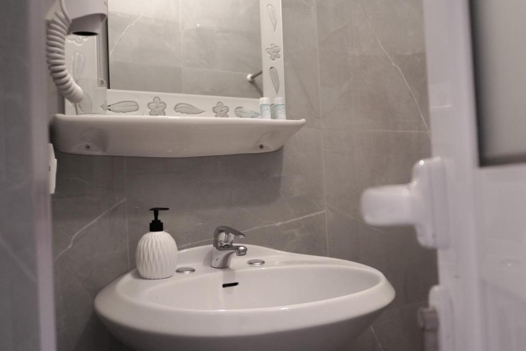 a bathroom with a sink and a mirror at Marku Palace in Ksamil