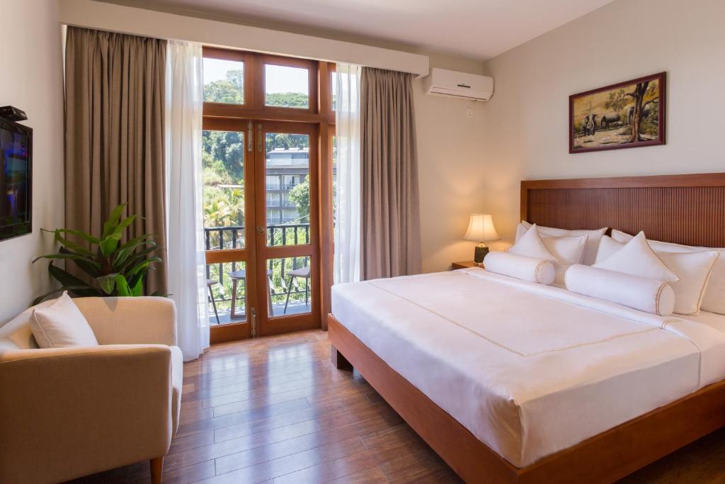 Postel nebo postele na pokoji v ubytování Serene Kandy