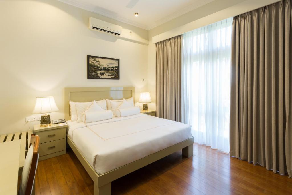 Postel nebo postele na pokoji v ubytování Serene Kandy