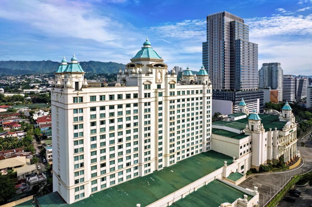 an aerial view of a large white building with green roofs at Waterfront Cebu City Hotel & Casino in Cebu City