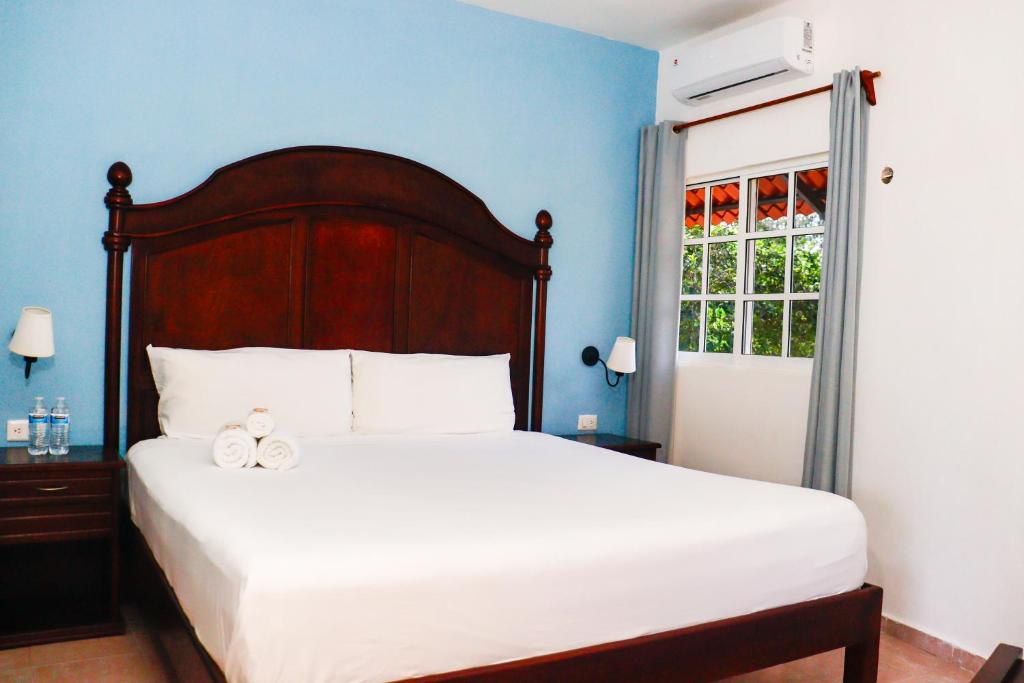 Postel nebo postele na pokoji v ubytování Hotel Quinta Izamal