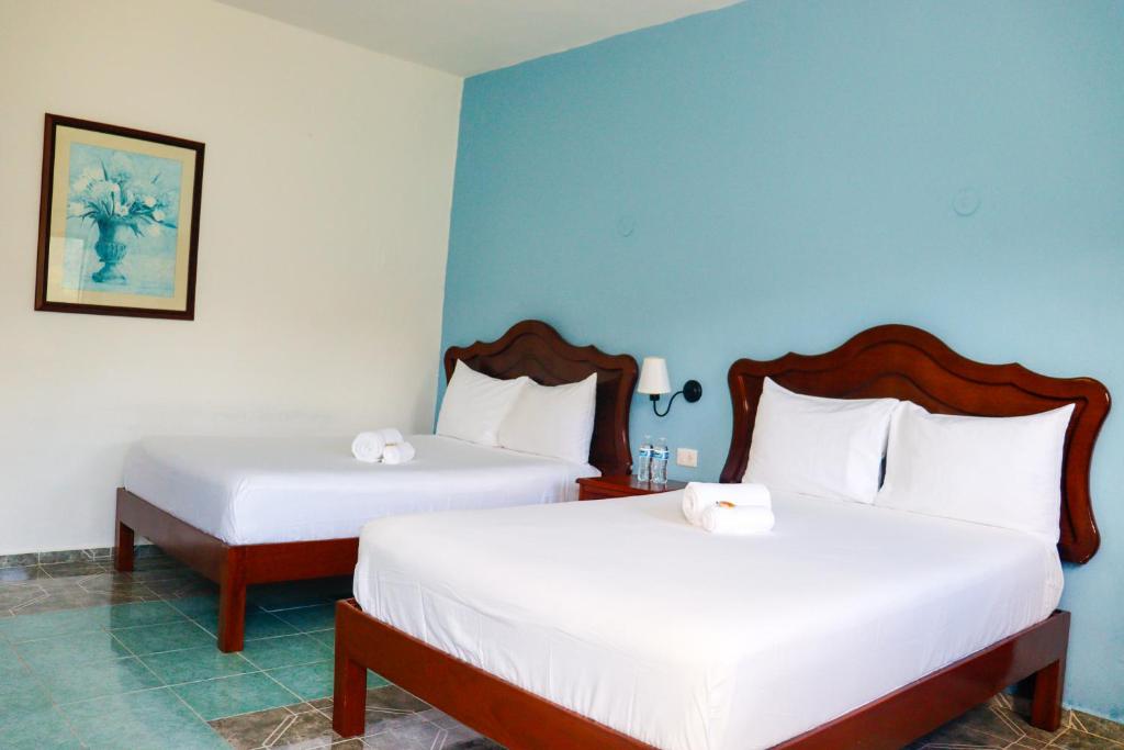 Postel nebo postele na pokoji v ubytování Hotel Quinta Izamal