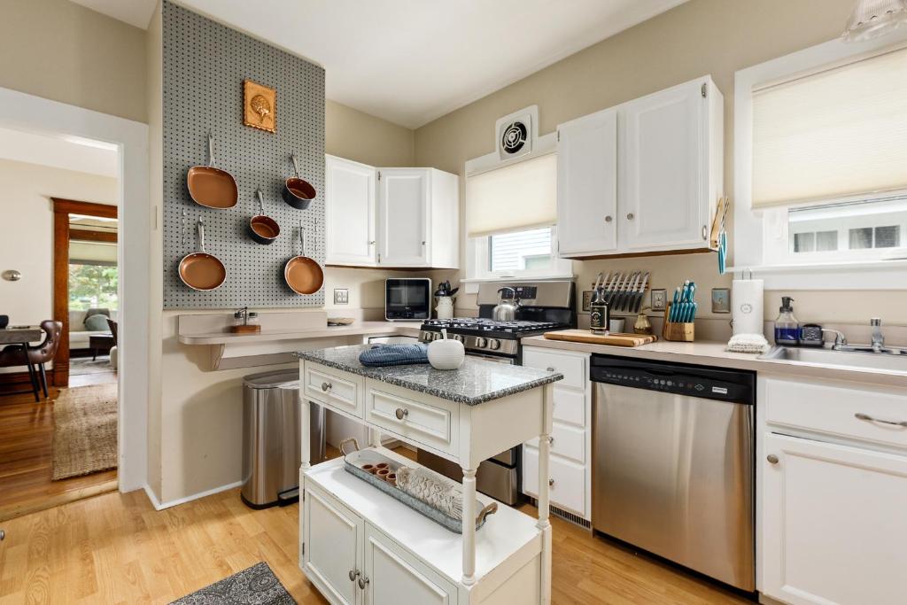 a kitchen with white cabinets and a counter top at Ninth Street Urban Retreat in Traverse City