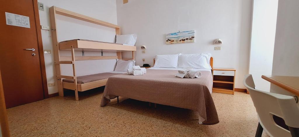 Postel nebo postele na pokoji v ubytování Hotel Sasselli