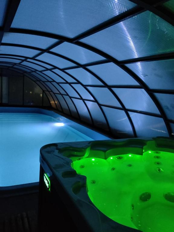 a room with a green pool with a blue ceiling at Osada Jantar - Holiday in Jantar