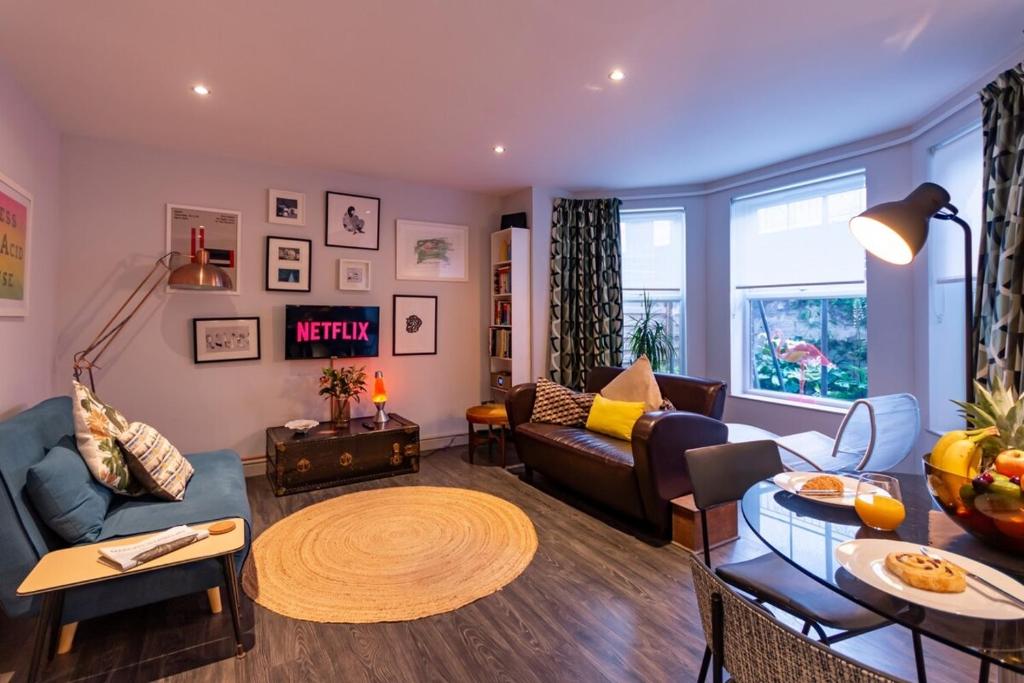 a living room with a couch and a table at Walpole Bay 2 Bed Stunning Garden Apt By Adliv in Margate