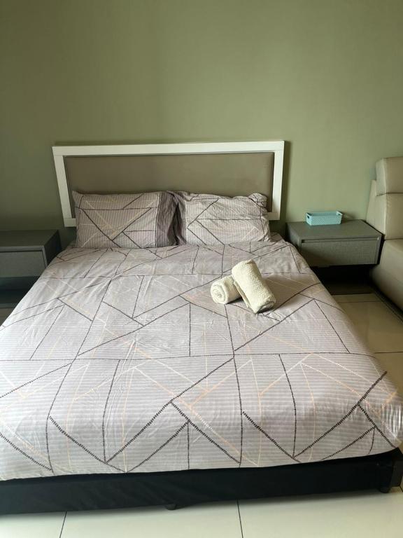 a bed with two towels on top of it at Evo Green Tea 25 with Netflix in Bandar Baru Bangi