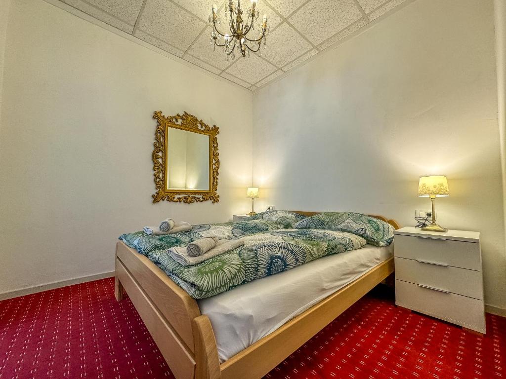 a bedroom with a bed and a mirror on the wall at Apartmaji Vogelnik in Radovljica