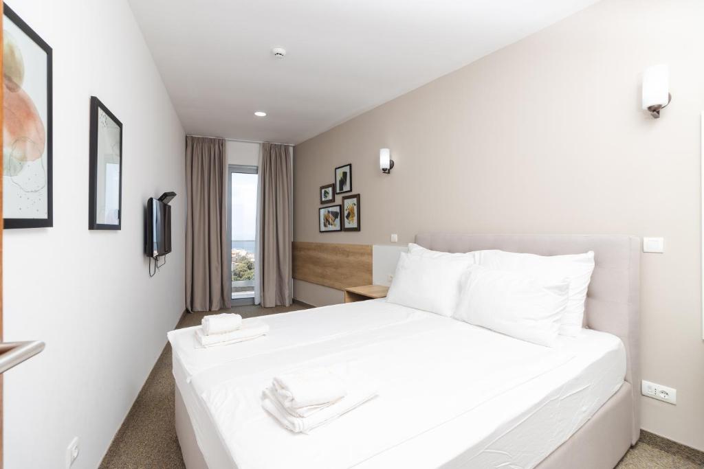 Vuode tai vuoteita majoituspaikassa Lux Hotel M