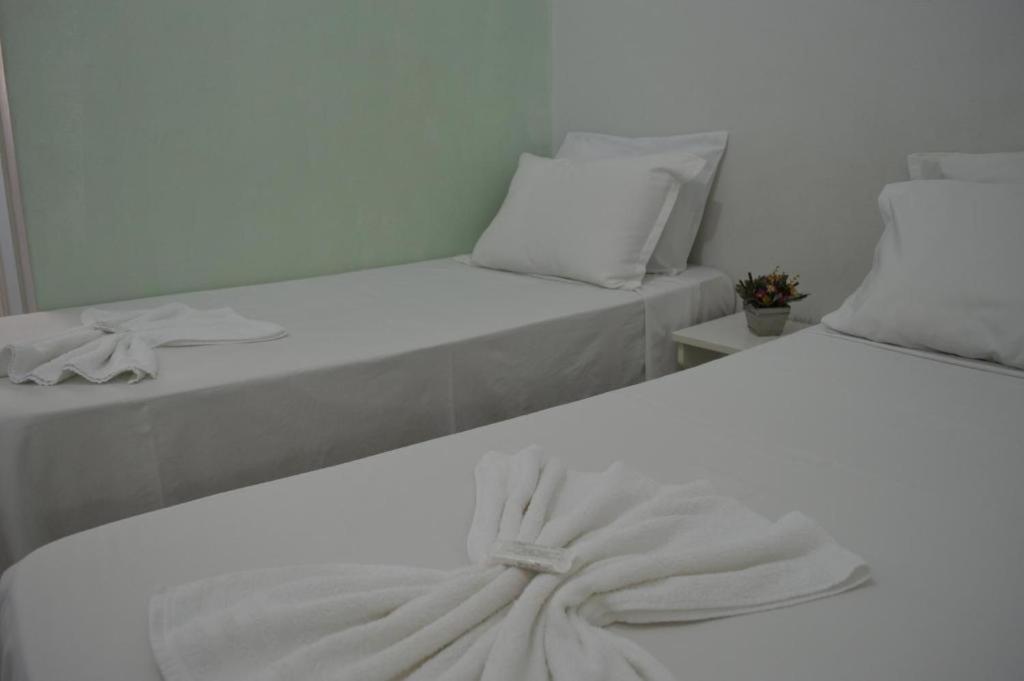 Postel nebo postele na pokoji v ubytování Hotel Confort Maringá