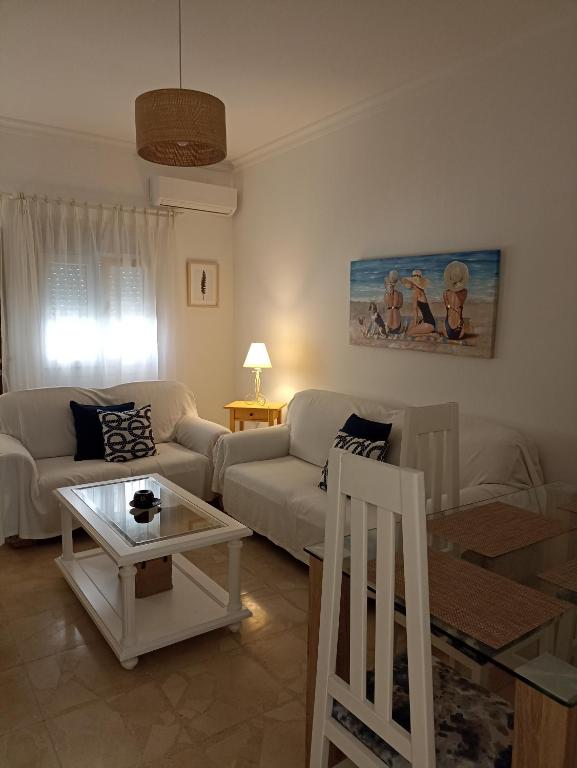 a living room with a couch and a table at Piso vacacional en Sanlúcar in Sanlúcar de Barrameda