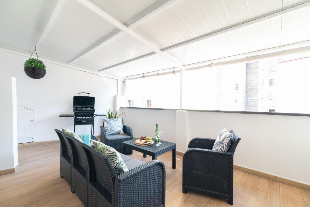 uma sala de estar com duas cadeiras e uma mesa em Gran Atico con terraza em Vigo