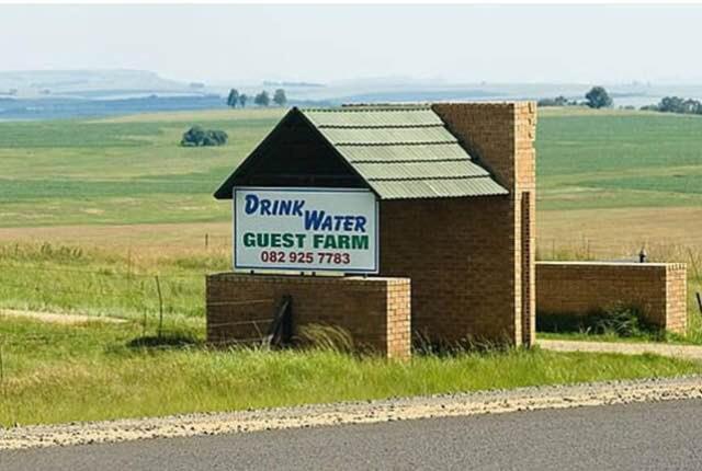 a drink water guest farm sign on the side of a road at Drinkwater Guest Farm in Grootgewaagd