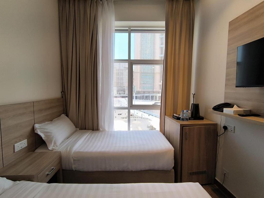 Postel nebo postele na pokoji v ubytování Worth Elite Hotel