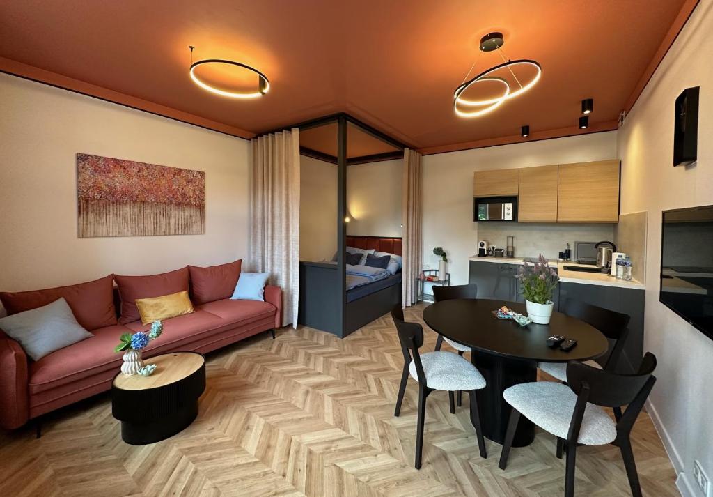 a living room with a couch and a table at Apartament TAMAJA in Bielsko-Biala
