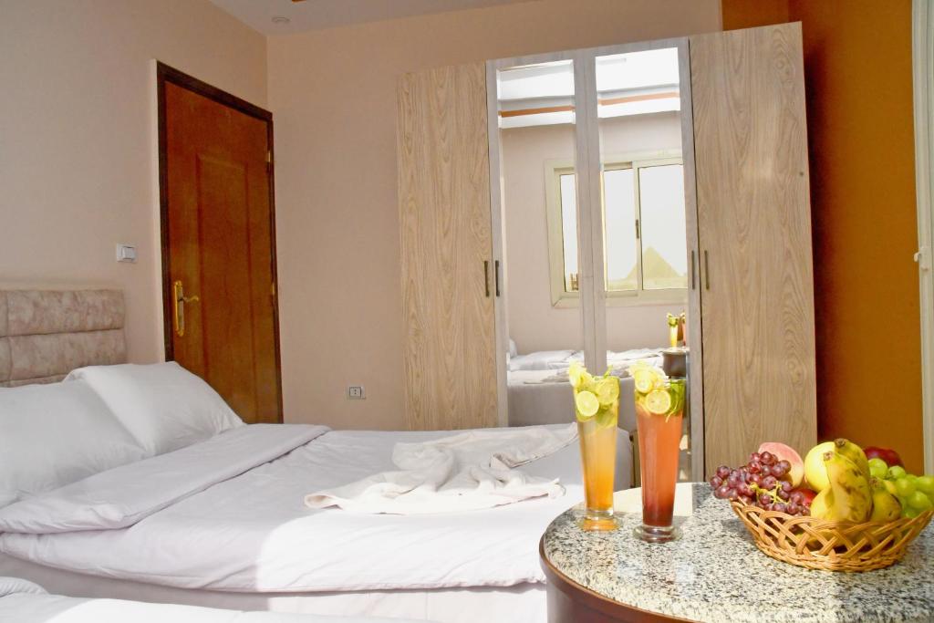 Postel nebo postele na pokoji v ubytování Nun Pyramids Hotel
