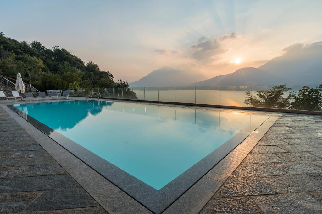 a swimming pool with a view of the water at paradiso del lago t4 in Bellano