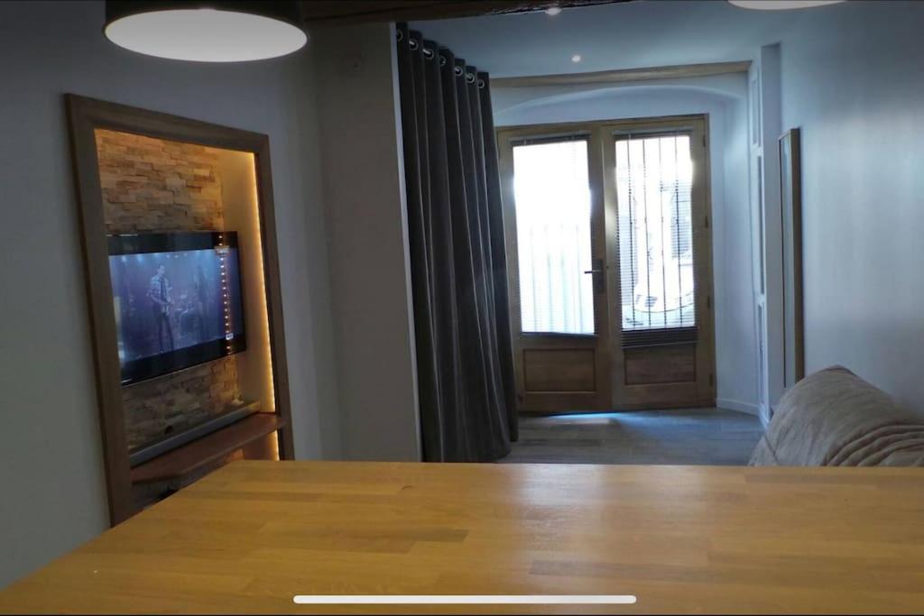 un salon avec une table et une télévision dans l'établissement Beau studio avec mezzanine, à Antibes