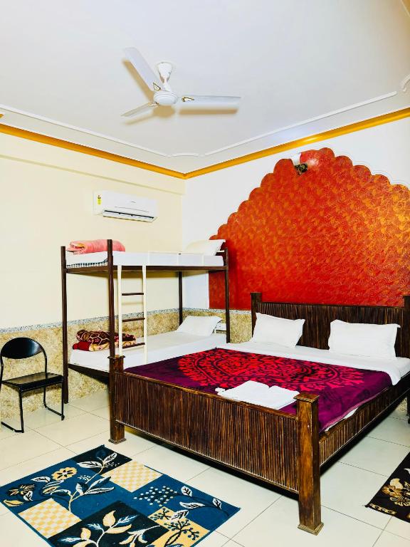 a bedroom with two bunk beds and a ceiling at MOONLIGHT HOMESTAY & HOSTEL in Jaipur