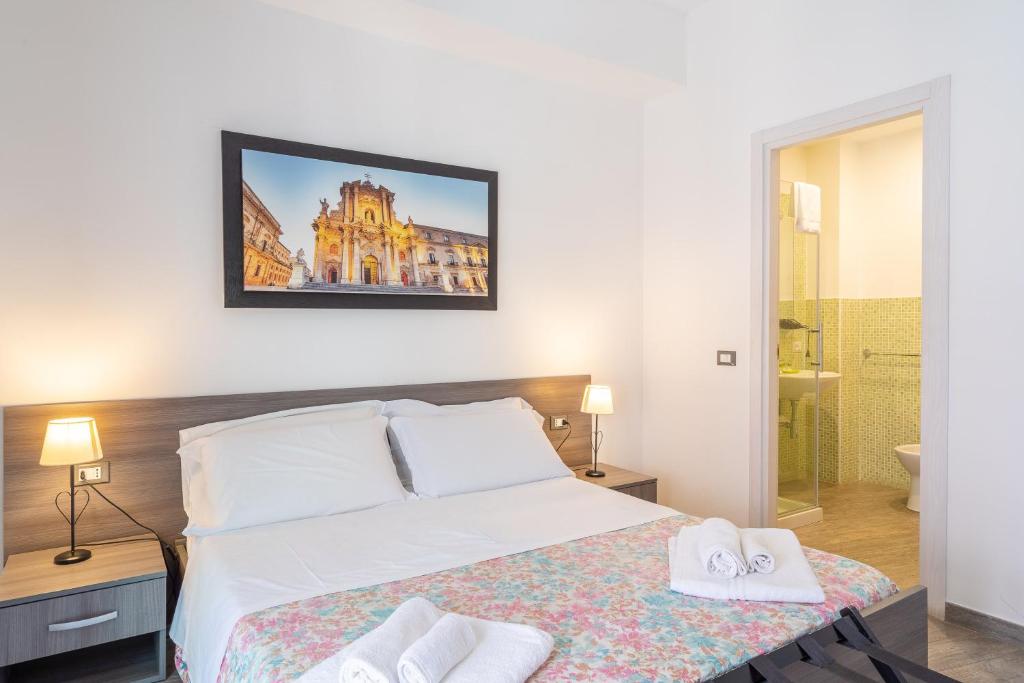 Postel nebo postele na pokoji v ubytování Cavour Rooms