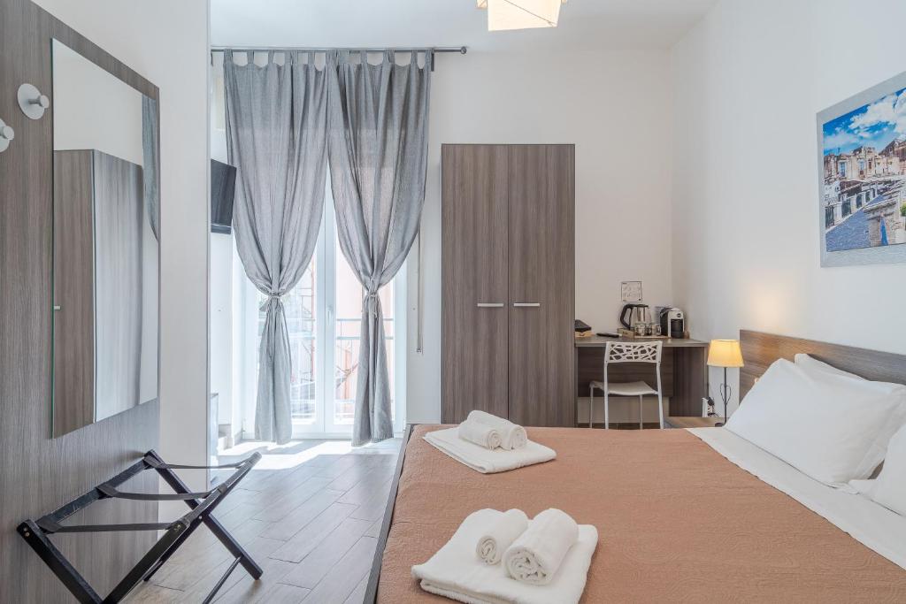 Postel nebo postele na pokoji v ubytování Cavour Rooms