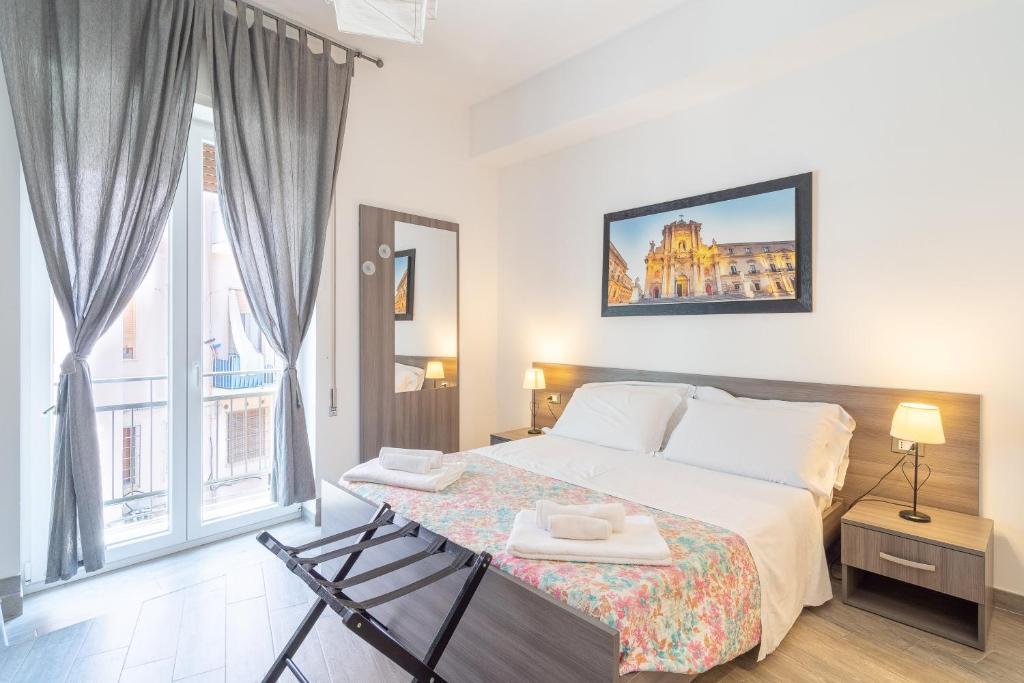 Postel nebo postele na pokoji v ubytování Cavour Rooms