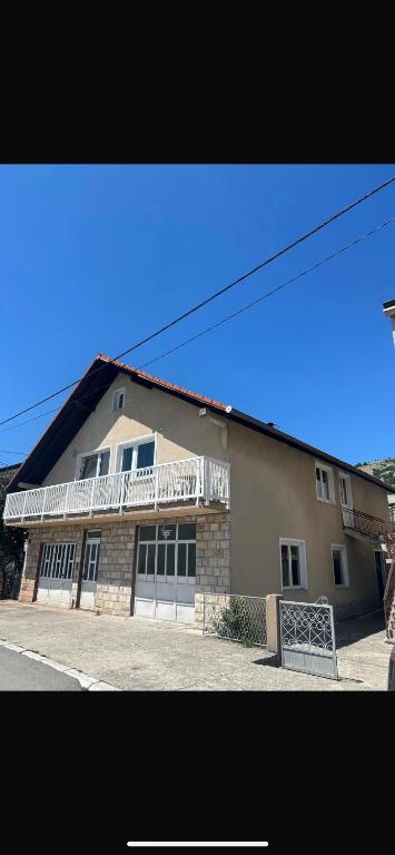 a large building with a balcony on top of it at Apartman Pavić in Livno