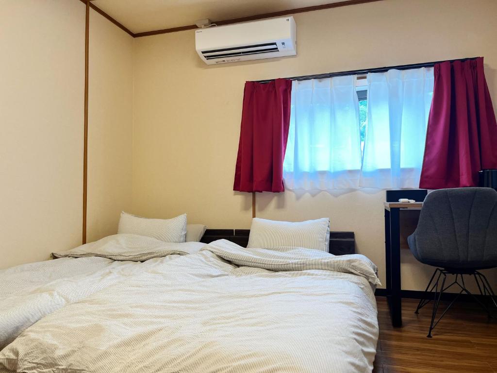 Postel nebo postele na pokoji v ubytování Jinya Sunset Inn by Murasaki