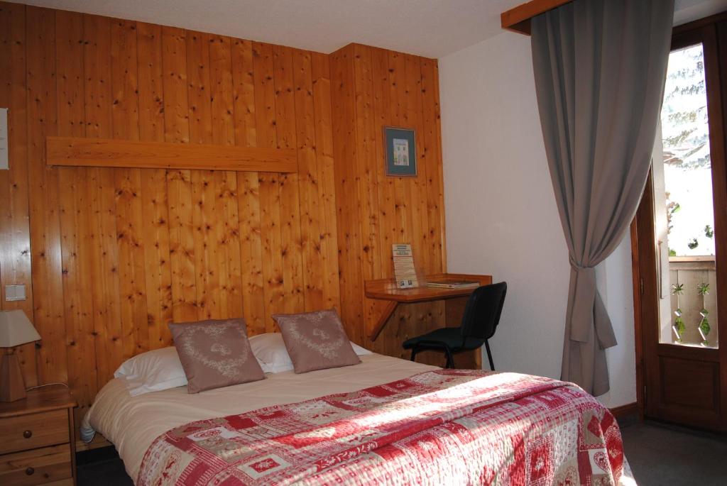 Postel nebo postele na pokoji v ubytování Hotel Val Joly