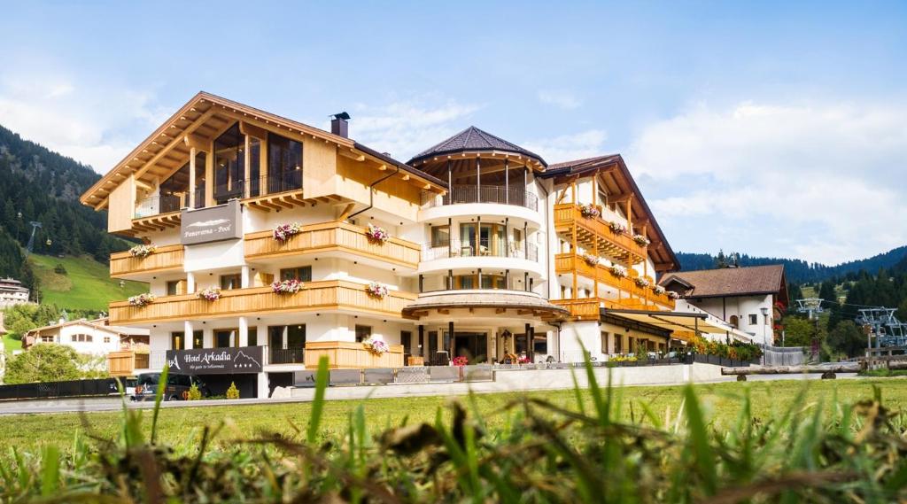 a large building in the middle of a field at Hotel Arkadia - "Adults Only" in Corvara in Badia