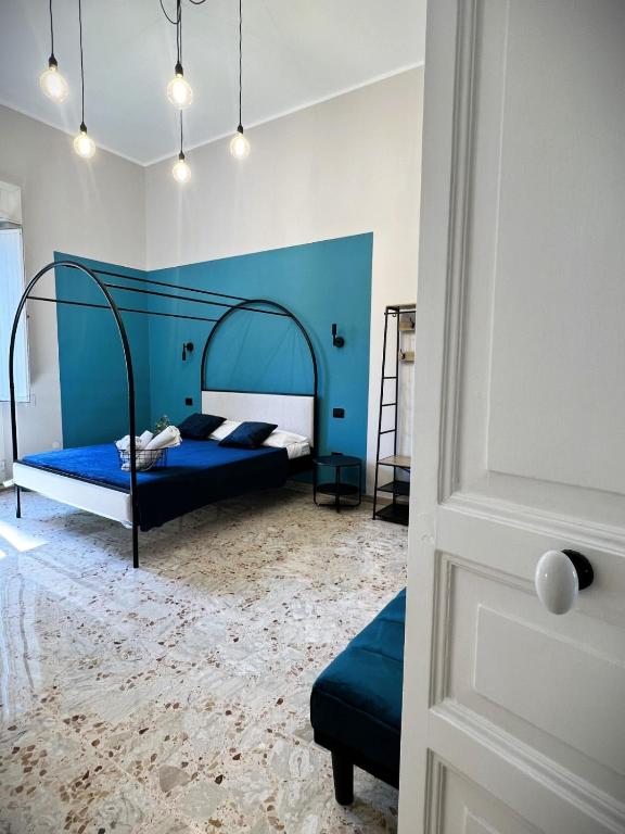 Hotel Lucky Corner - Elegant Stay, a bedroom with a bed with a blue headboard at Lucky Corner - Elegant Stay in Taranto