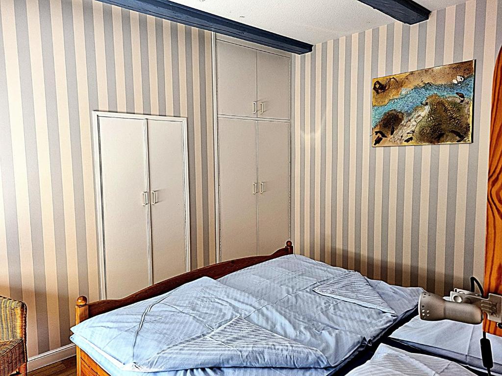 a bedroom with a bed and a painting on the wall at Ferienhof Bisdorf "Schwülkennest" Reihenhaus in Bisdorf