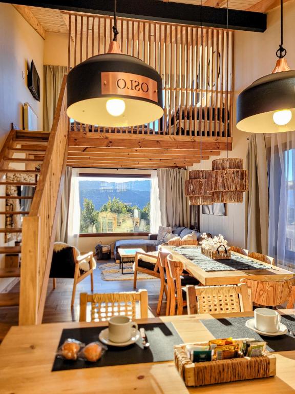 a living room with a table and some chairs at Ailen de los Andes Deluxe in San Martín de los Andes