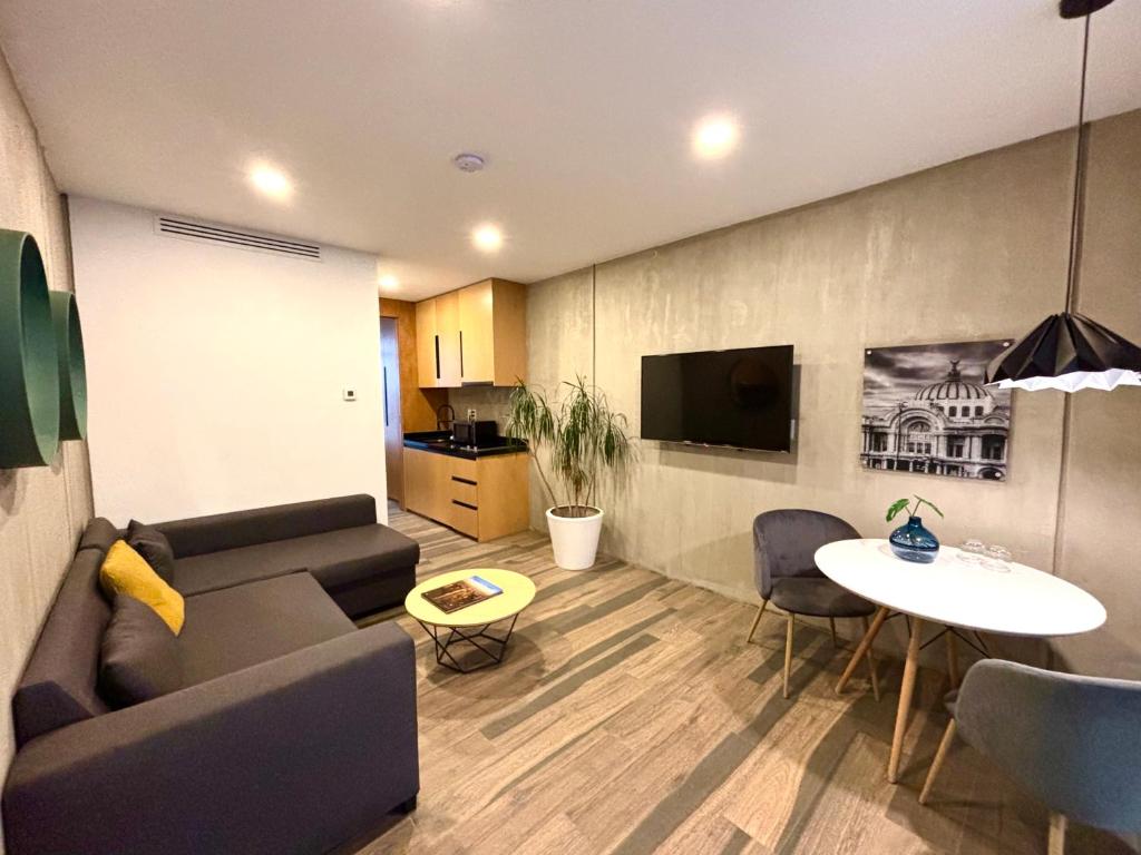 a living room with a couch and a table at Park Life Condesa Hipódromo in Mexico City