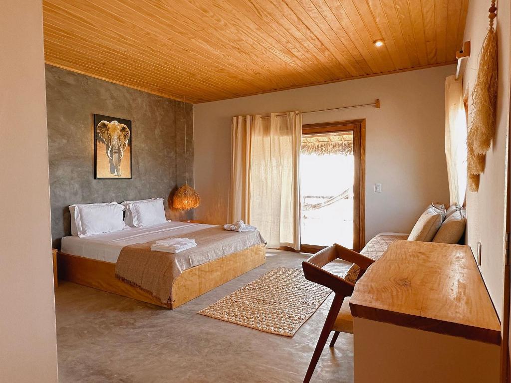 a bedroom with a large bed and a window at Casa Caju Tatajuba in Tatajuba