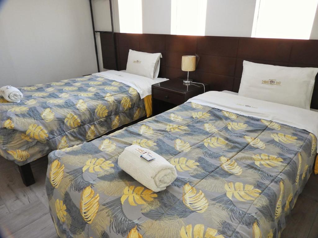 Postel nebo postele na pokoji v ubytování Sumaq Wasi Apart Hotel