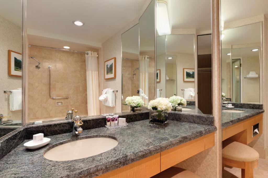 a bathroom with a sink and a large mirror at Harrah's Lake Tahoe Hotel & Casino in Stateline
