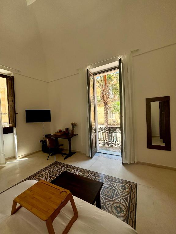 sala de estar con cama y puerta corredera de cristal en Palazzo Conserva, en Brindisi