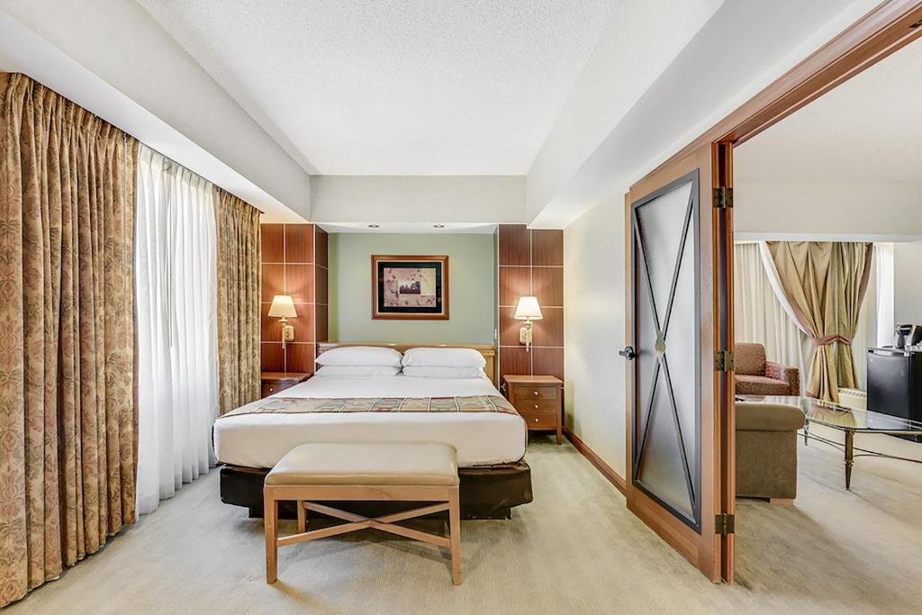 a hotel room with a bed and a chair at Harrah's Lake Tahoe Hotel & Casino in Stateline