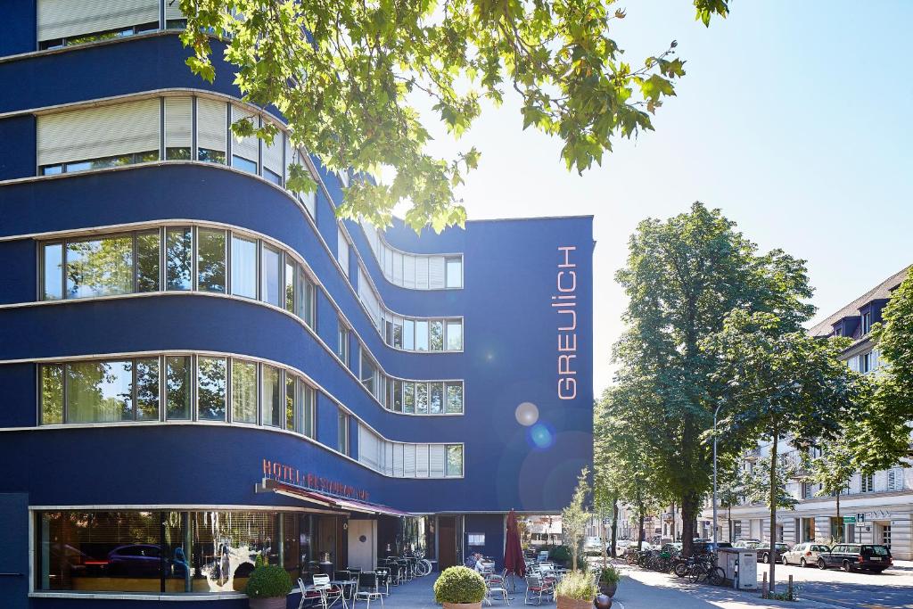 a large building with a sign on the side of it at Greulich Design & Boutique Hotel in Zurich